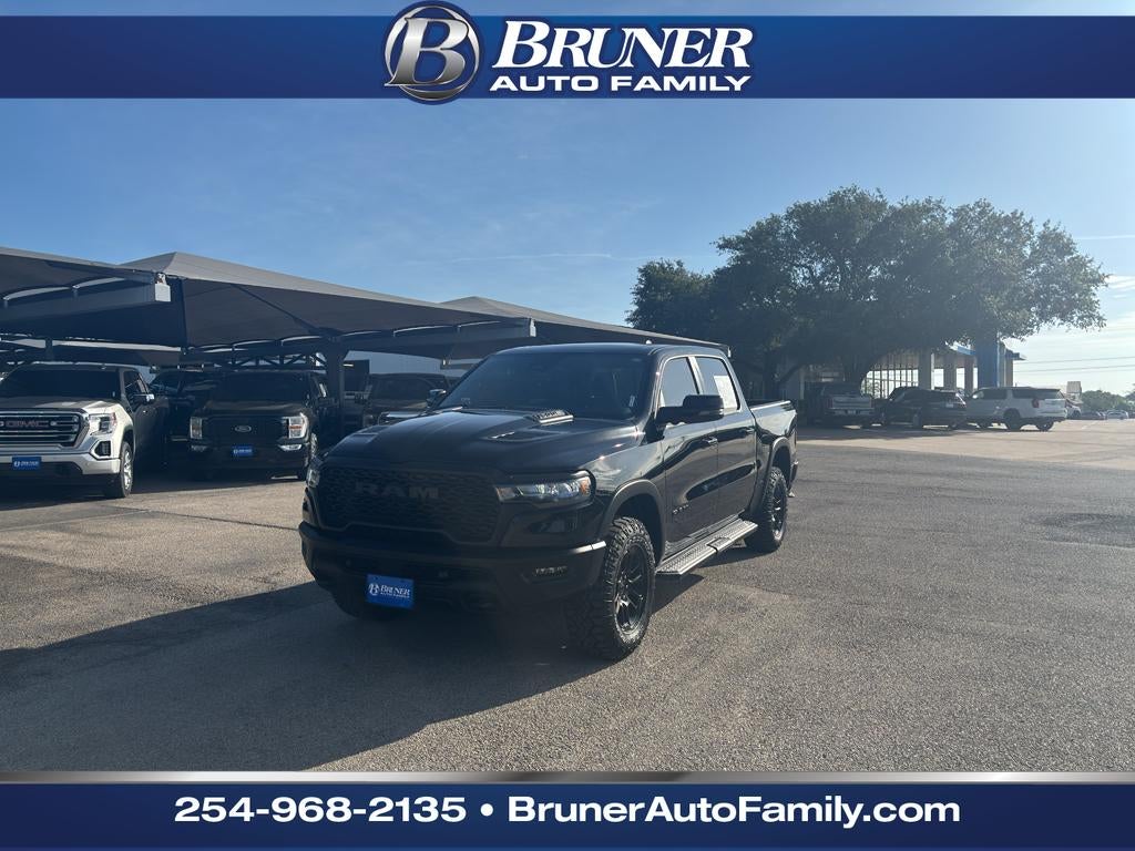 2025 RAM 1500 Rebel Crew Cab 4x4 5'7" Box in Black — front three-quarter view