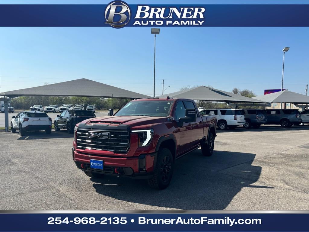 2026 GMC Sierra 2500 HD AT4 in Volcanic Red Tintcoat — front three-quarter view